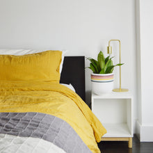 bright bedroom with Retro plant pot on white nightstand