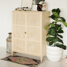 white and tan rugby striped planter pot with a fiddle leaf fig next to a white washed cane credenza.  Decorative beige and white striped plant pot with drainage hole. Perfect for large and small plants and trees. Great for setting on the floor for an aesthetic look.