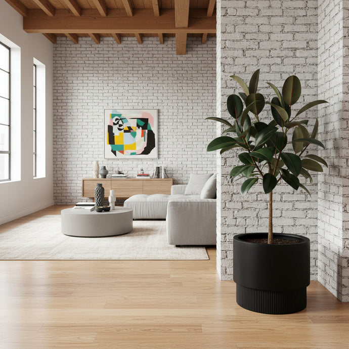 Modern living room with a plant in the foreground and a colorful abstract painting on the wall.