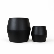 Two black fiberstone pots of different sizes on a white background
