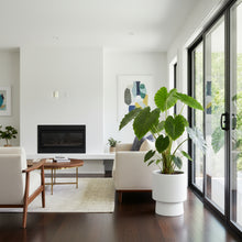 Modern living room with white walls, a fireplace, and a large window.