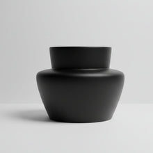 Black fiberstone vase on a light grey background