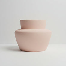 Pink ceramic vase on a light gray background