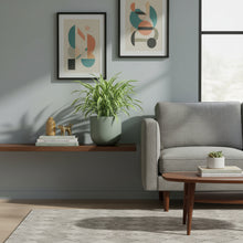 Modern living room with gray sofa, wooden coffee table, and abstract art on the wall.