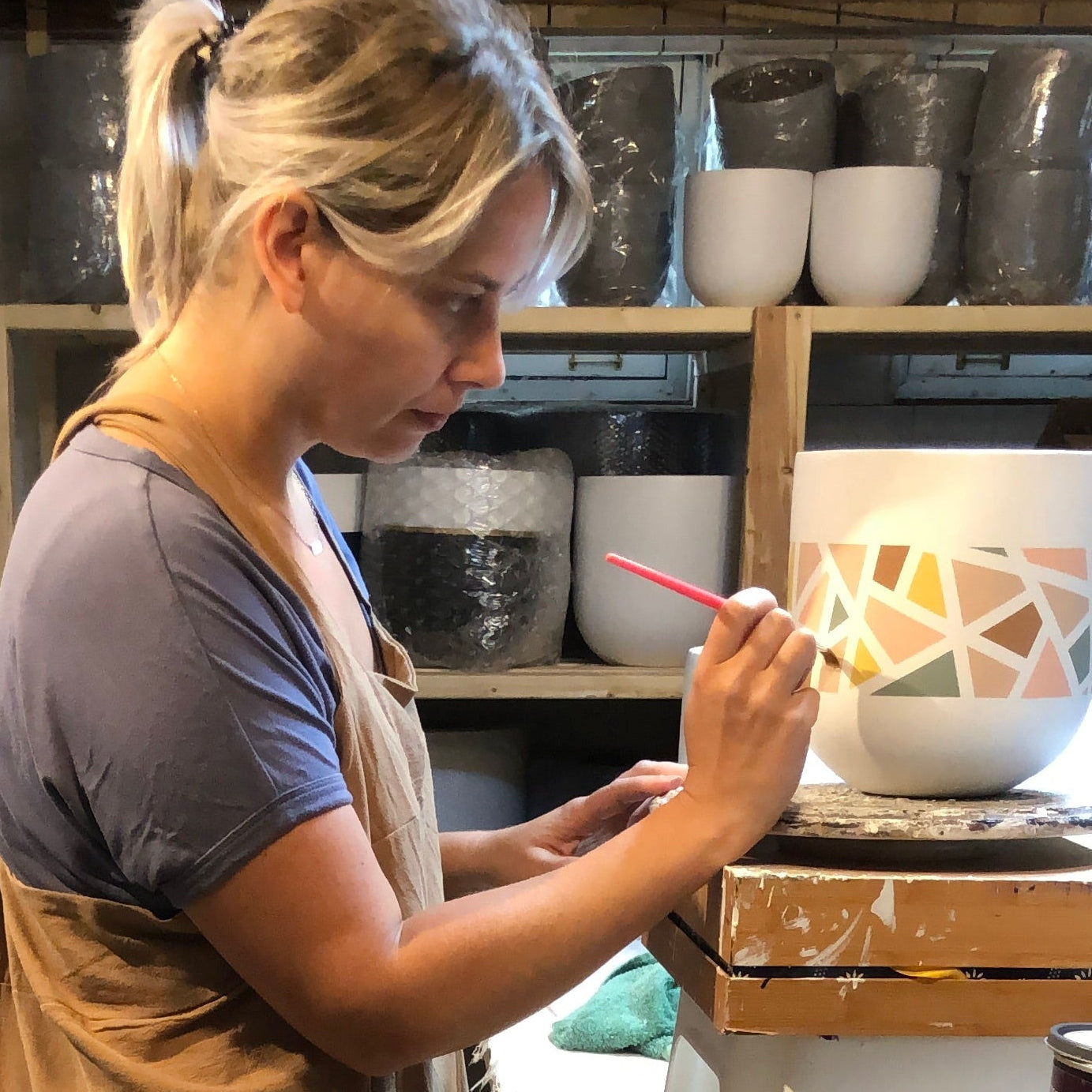 Person working in a workshop with tools and materials around