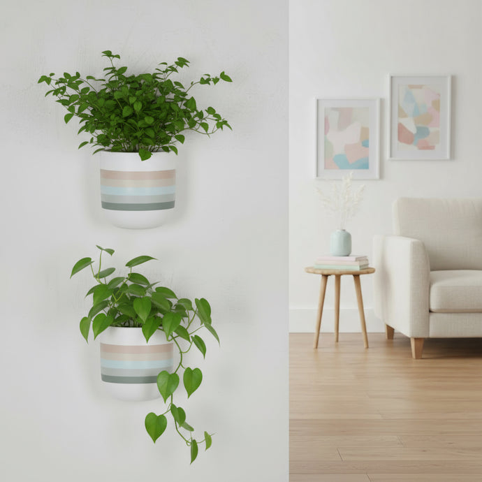 Two wall-mounted planters with green plants in a room with a couch and side table.