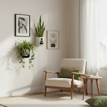 Modern living room with a wooden armchair, side table, and wall art.