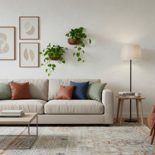 Modern living room with a beige sofa, colorful cushions, and decorative elements.