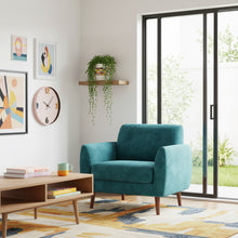 colourful. living area with blue armchair,  abstract art and coffee table.