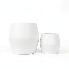 Two white fiberstone pots on a white background