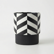 Black and white geometric cylindrical pedestal plant pot on a light grey background