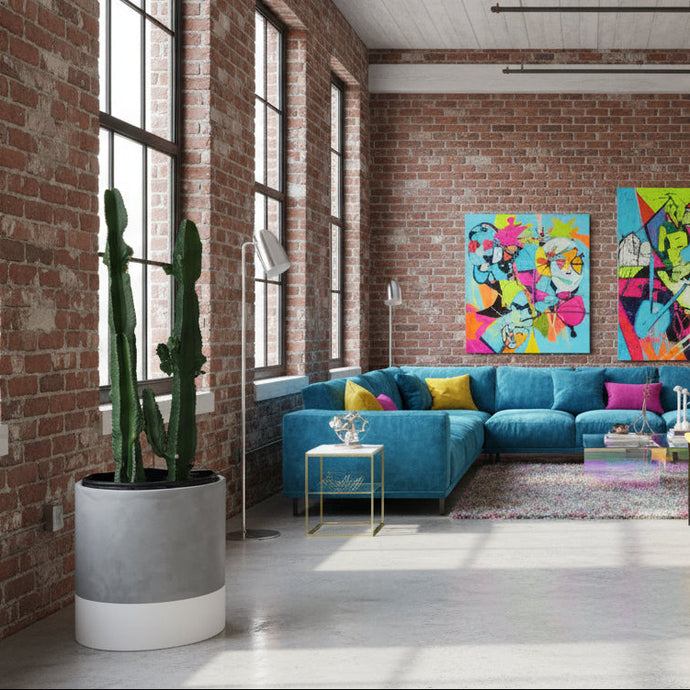 Modern living room with colorful decor and a brick wall.