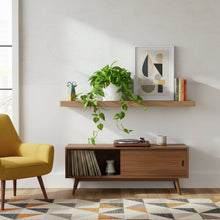 Modern living room with wooden shelf, chair, and decor items.
