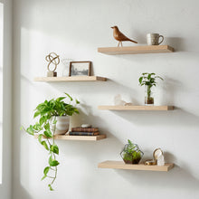 Wooden shelves with decorative items on a white wall