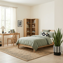 Modern bedroom with wooden bed, bookshelf, and desk.
