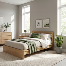 Modern bedroom with wooden bed, green and white bedding, and decorative elements.