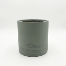 Olive green fiberstone planter with decorative snake pattern on a white background