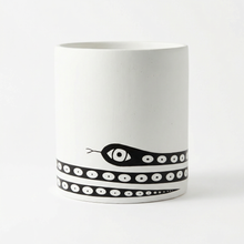 White fiberstone plant pot with black and white snake design on a white background