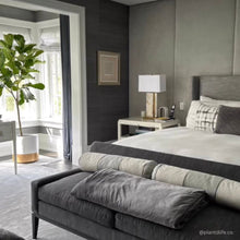 Modern white cylinder planter with contrasting gold base in modern bedroom