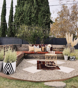 white and black diamond pattern planter in outdoor bohemian sitting space
