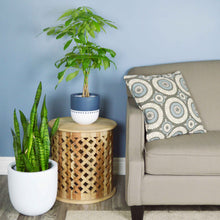 navy and white planters on wood side table placed next to couch