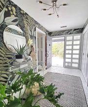 black and white boho planter pot in an entryway with foliage wall paper design