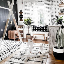 black and white planter pot in boy's monochromatic decor room with euphorbia cowboy cactus