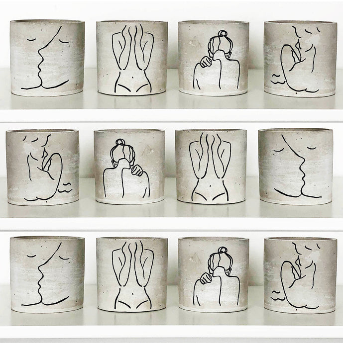Twelve mini Forgotten Property concrete planters on a white shelf
