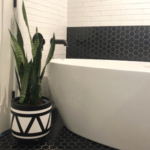 black and white aztec design planter pot in a monochrome, modern bathroom