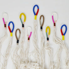 collection of cotton twine plant hangers with colourful woven loops