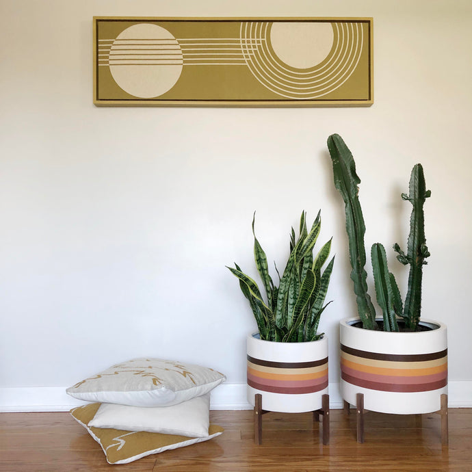 set of mid century modern designed with retro stripes on low cylinder planter pots
