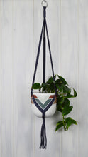 Hand painted Marrakesh Common House Studio planter pot hanging in a Navy plant hanger